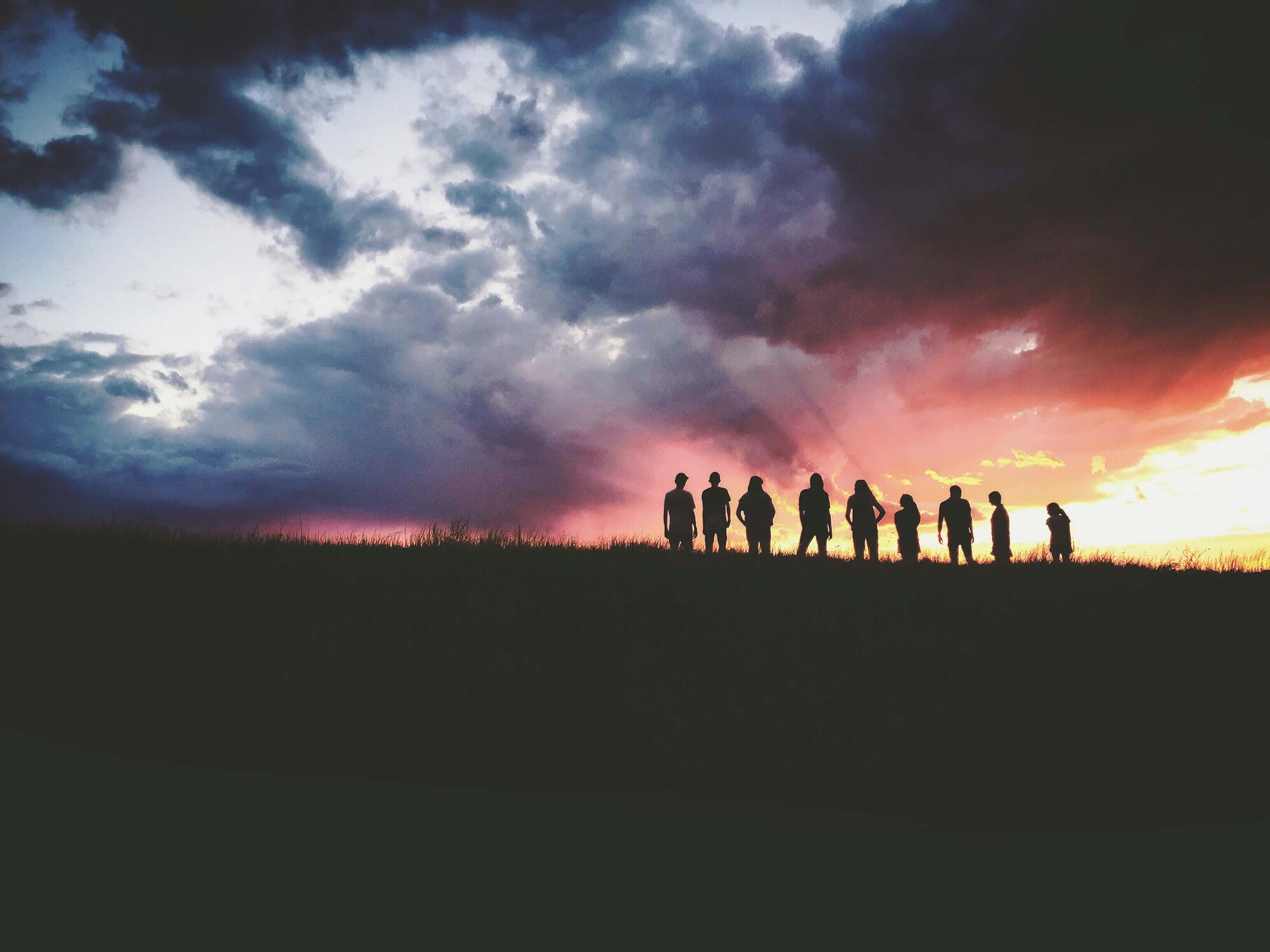 nine people sky silhouette